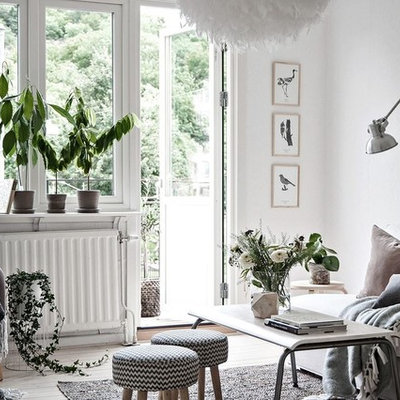 Inspiration for a mid-sized scandinavian formal light wood floor living room remodel in Gothenburg with white walls and no tv