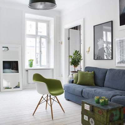 Inspiration for a large scandinavian open concept painted wood floor living room remodel in Stockholm with white walls, no fireplace and no tv