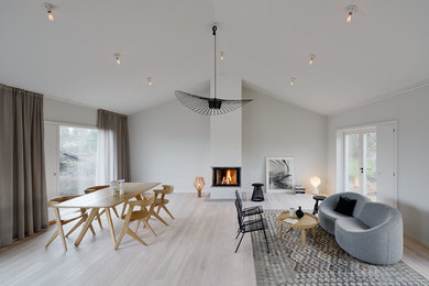Mid-sized danish formal and open concept light wood floor living room photo in Stockholm with white walls and no tv