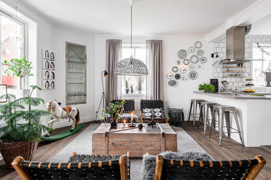 Large scandi open plan living room in Gothenburg with white walls and dark hardwood flooring.