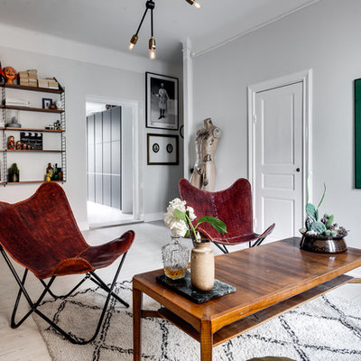 Example of a mid-sized danish formal and open concept light wood floor living room design in Stockholm with white walls, no fireplace and no tv