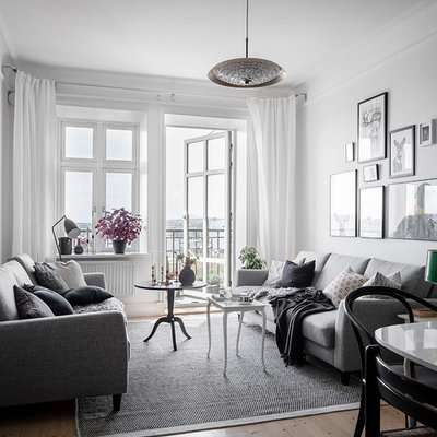 Inspiration for a scandinavian formal and open concept light wood floor and beige floor living room remodel in Gothenburg with white walls