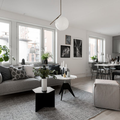 Inspiration for a mid-sized scandinavian formal and open concept light wood floor and beige floor living room remodel in Stockholm with white walls