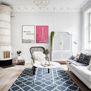 Inspiration för ett mellanstort skandinaviskt separat vardagsrum, med ljust trägolv, en öppen hörnspis, en spiselkrans i trä, beiget golv och grå väggar