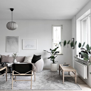 Idéer för att renovera ett minimalistiskt vardagsrum, med vita väggar, ljust trägolv och beiget golv