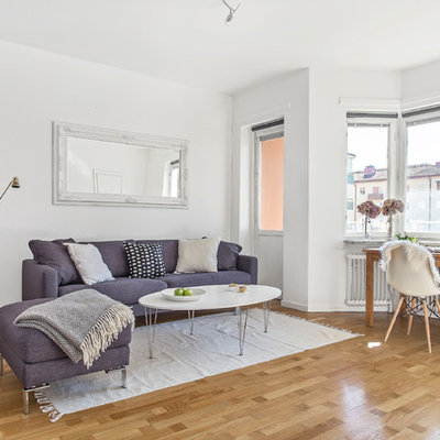 Inspiration for a mid-sized scandinavian formal and open concept light wood floor living room remodel in Stockholm with white walls and no tv