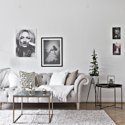 Inspiration for a mid-sized scandinavian formal and open concept light wood floor living room remodel in Gothenburg with white walls and no tv