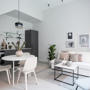 Inspiration för ett litet minimalistiskt allrum med öppen planlösning, med vita väggar och grått golv