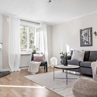 Exempel på ett mellanstort nordiskt separat vardagsrum, med beige väggar, ljust trägolv, en öppen hörnspis, en spiselkrans i sten och beiget golv