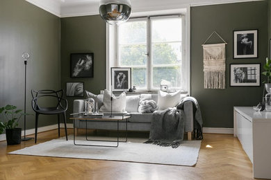 Foto på ett mellanstort skandinaviskt vardagsrum, med svarta väggar och mellanmörkt trägolv