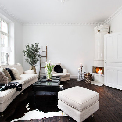 Danish formal and open concept dark wood floor living room photo in Malmo with white walls, a corner fireplace and no tv