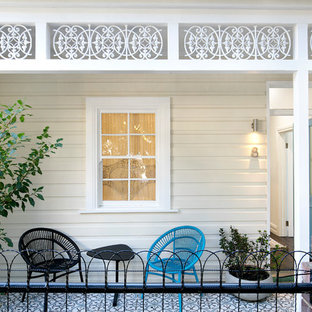 Transitional front yard verandah in Sydney with tile and a roof extension.