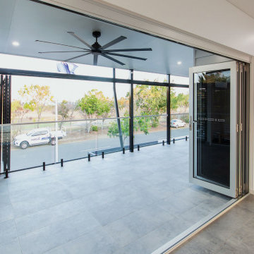 Aluminium Bi fold Doors with grey glass opening to a balcony