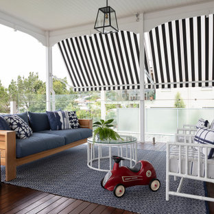 Mid-sized transitional backyard verandah in Brisbane with decking and a roof extension.