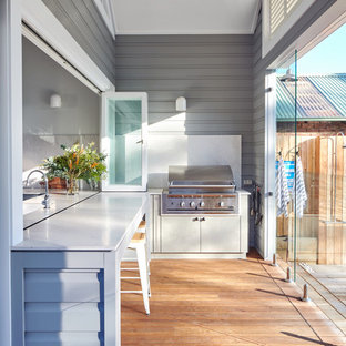 Photo of a transitional verandah in Sydney with an outdoor kitchen, decking and a roof extension.