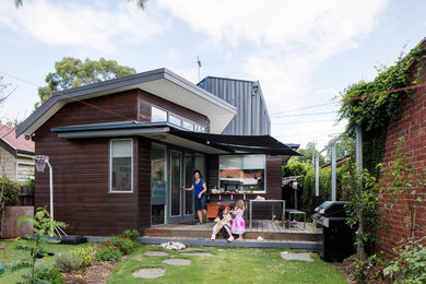 Inspiration för mellanstora moderna verandor på baksidan av huset, med naturstensplattor och en pergola