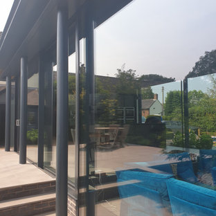 Ispirazione per un piccolo portico minimal dietro casa con pavimentazioni in pietra naturale e un tetto a sbalzo