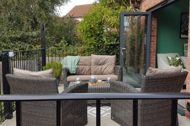 This is an example of a large modern back veranda in Essex with decking.