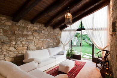 Foto på ett litet lantligt uterum, med klinkergolv i terrakotta och tak