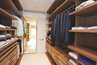 Photo of a contemporary walk-in wardrobe for men in London with open cabinets and medium wood cabinets.