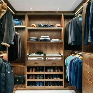Inspiration for a medium sized contemporary walk-in wardrobe for men in Essex with flat-panel cabinets, medium wood cabinets, white floors and carpet.