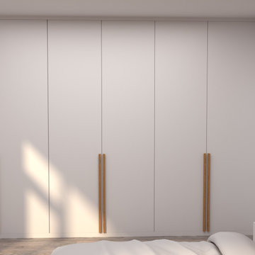 Fitted bedroom furniture with long wooden handles and wall panelling