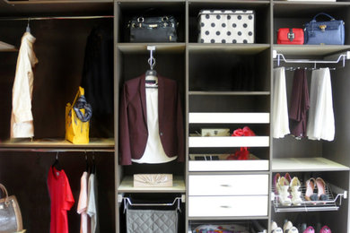Walk-in closet - large contemporary gender-neutral walk-in closet idea in Other with open cabinets and gray cabinets