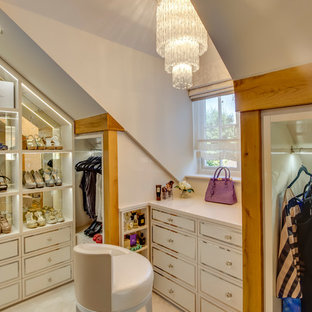 Large traditional walk-in wardrobe for women in Other with recessed-panel cabinets, beige cabinets, carpet and beige floors.