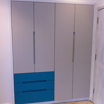 turquoise grab handle wardrobe with LED lighting and walnut interiors