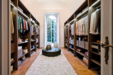 Walk-in closet - huge traditional gender-neutral medium tone wood floor and brown floor walk-in closet idea in Toronto with open cabinets and dark wood cabinets