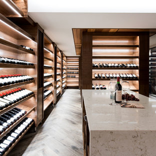Photo of a contemporary wine cellar in Sunshine Coast with display racks and brown floor.