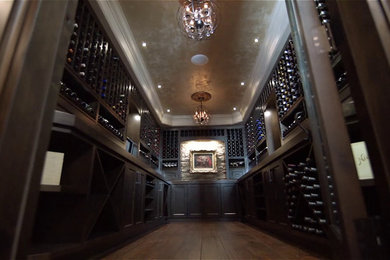 Large classic wine cellar in Vancouver with medium hardwood flooring and display racks.