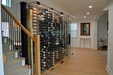 Small trendy brown floor wine cellar photo in Los Angeles with display racks