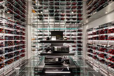 This is an example of a contemporary wine cellar in Toronto with storage racks.