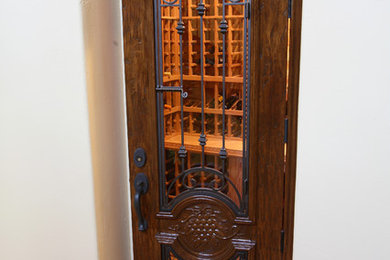 Arched Wine Cellar Door with Glass Insert and Wrought Iron Bars