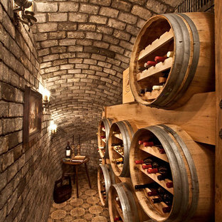 This is an example of a small mediterranean wine cellar in Orange County with storage racks.