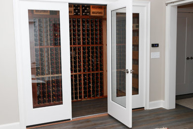 Inspiration for a mid-sized timeless dark wood floor and brown floor wine cellar remodel in Atlanta with storage racks