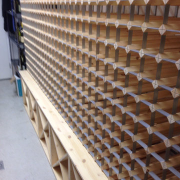 Basement wine cellar in London hotel using pine cubes and traditional racks