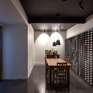 Mid-sized modern wine cellar in Melbourne with concrete floors, grey floor and storage racks.