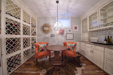 Example of a mid-sized classic medium tone wood floor and brown floor wine cellar design in DC Metro with storage racks