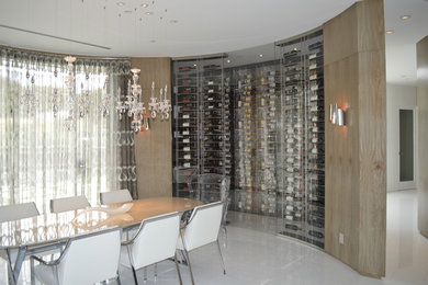 Example of a mid-sized minimalist marble floor wine cellar design in Los Angeles with display racks