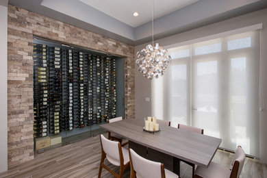 Small trendy medium tone wood floor wine cellar photo in Los Angeles with display racks