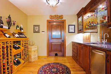 Elegant medium tone wood floor wine cellar photo in Other