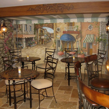 Cafe seating area surrounded by custom hand painted mural and ambient lighting