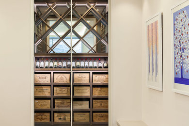 Photo of a small contemporary wine cellar in Surrey with dark hardwood flooring.