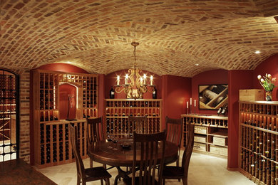 Huge elegant beige floor wine cellar photo in Denver with storage racks