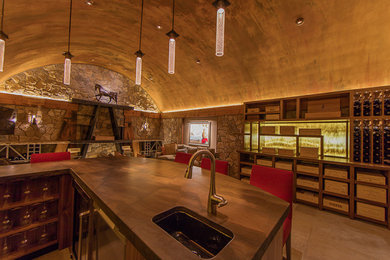 Example of a tuscan wine cellar design in Denver