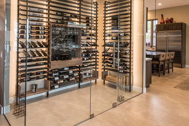 Wine cellar - large contemporary beige floor and porcelain tile wine cellar idea in Phoenix with display racks