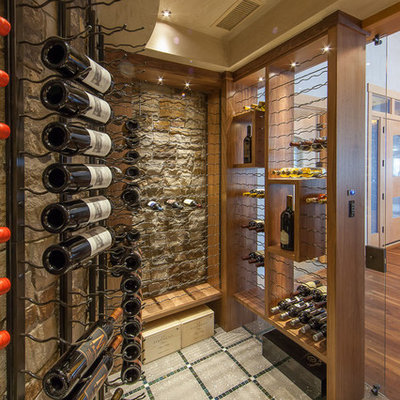 Inspiration for a large contemporary concrete floor and multicolored floor wine cellar remodel in Denver with display racks