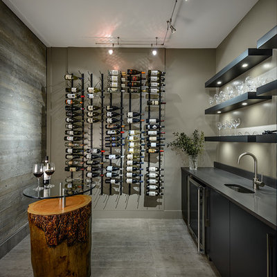 Wine cellar - contemporary concrete floor and gray floor wine cellar idea in Vancouver